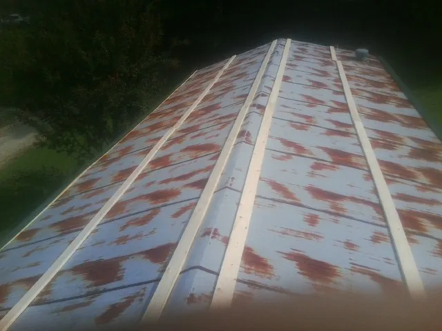 Rusted metal roof panels with new wood purlins before replacement — Storm Damage Roof Repair in Nanticoke by Roofing Brothers